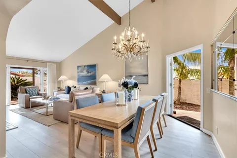 a view of a dining room with furniture wooden floor and chandelier