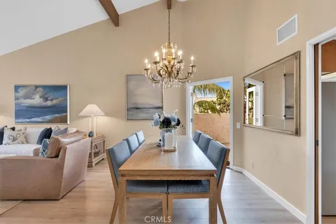 a view of a dining room with furniture and chandelier