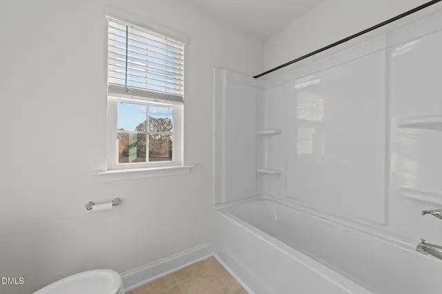 a bath room with a toilet and a bath tub