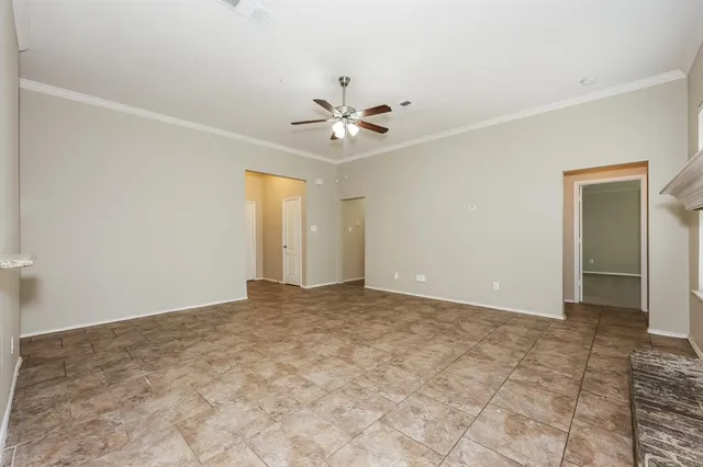 an empty room with closet and a ceiling fan