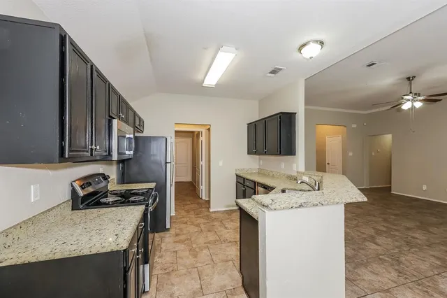 a kitchen with a sink stove and refrigerator