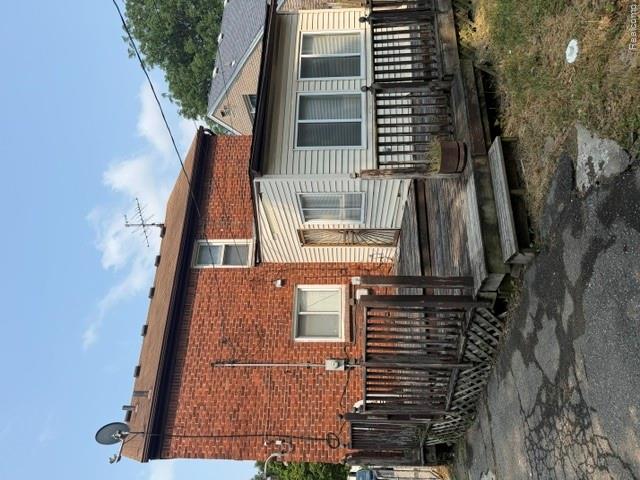 8144 Meyers Road Detroit, MI 48228 - Photo 3 of 19 Rear exterior featuring a brick facade with an attached wood deck