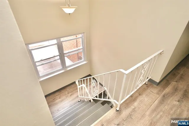 a view of staircase with white walls and a window