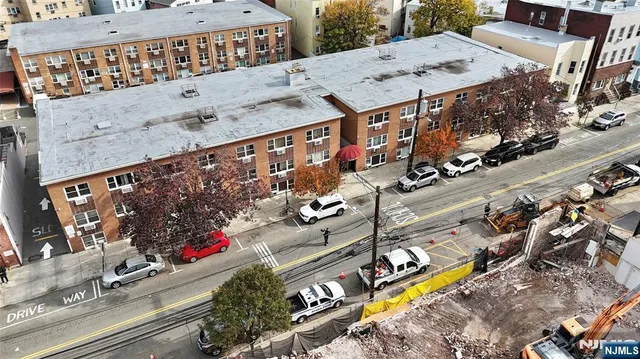 an aerial view of a swimming pool with outdoor space and seating area