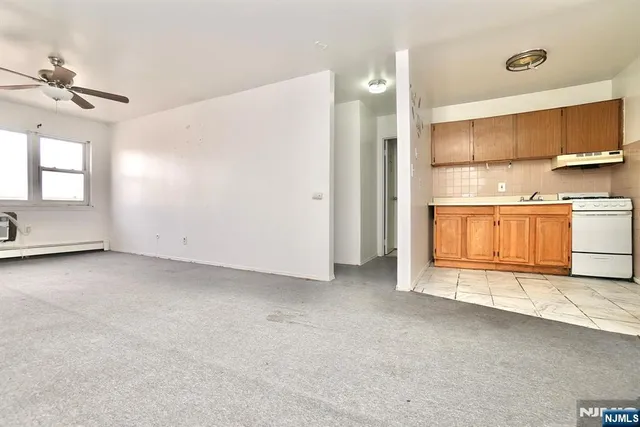 a view of a kitchen with a sink and dishwasher cabinets