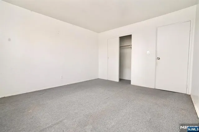 a view of an empty room and closet area