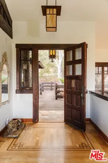 a view of a white house with a couches in a patio