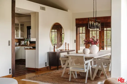 a living room with furniture and floor to ceiling windows