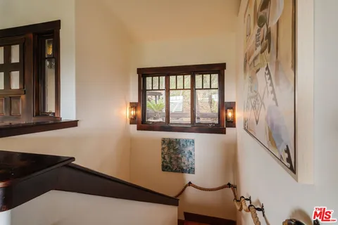 a bedroom with a bed dresser and a window