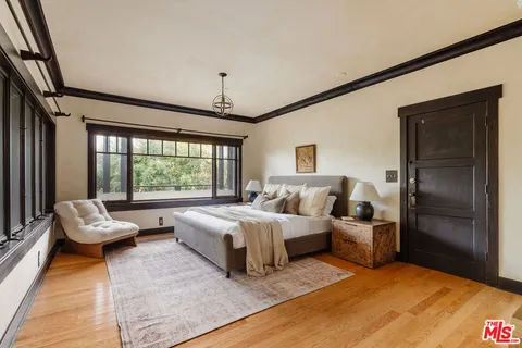 a bedroom with a large bed and a large window