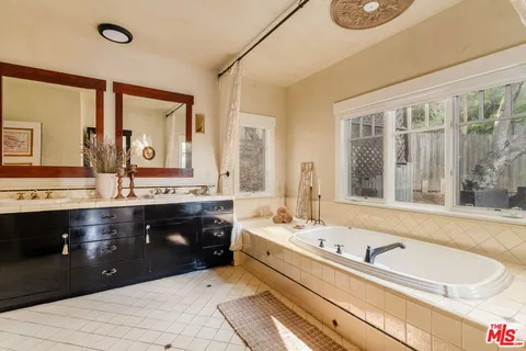 a kitchen with stainless steel appliances granite countertop a stove and a dining table with wooden floor