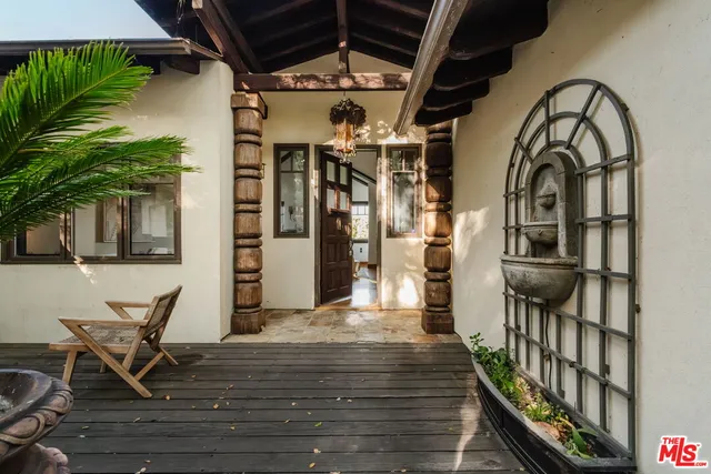 a view of a patio with a couch and wooden floor
