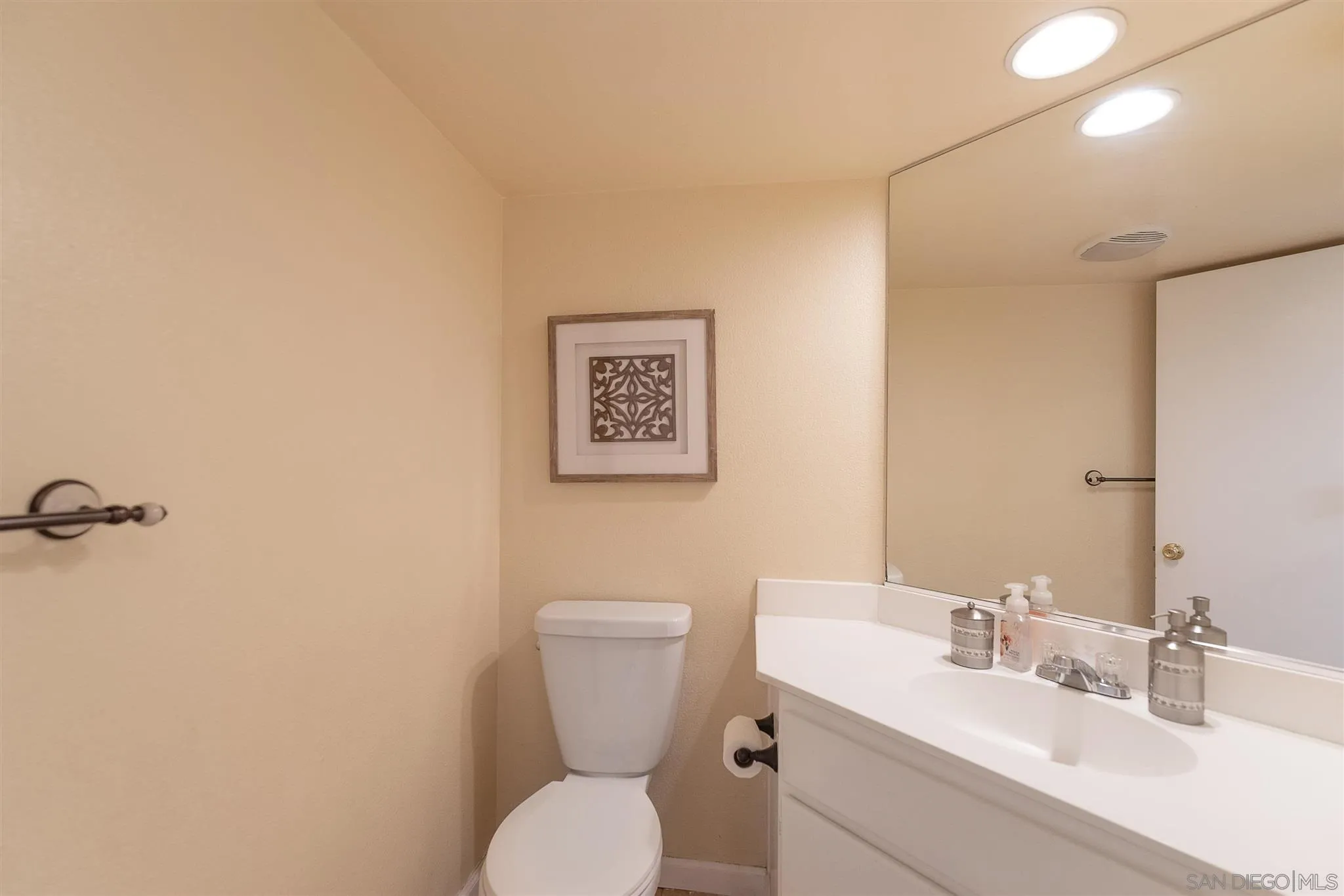 3208 Naylor Road San Diego, CA 92173 - Photo 12 of 24 a bathroom with a toilet a sink and mirror