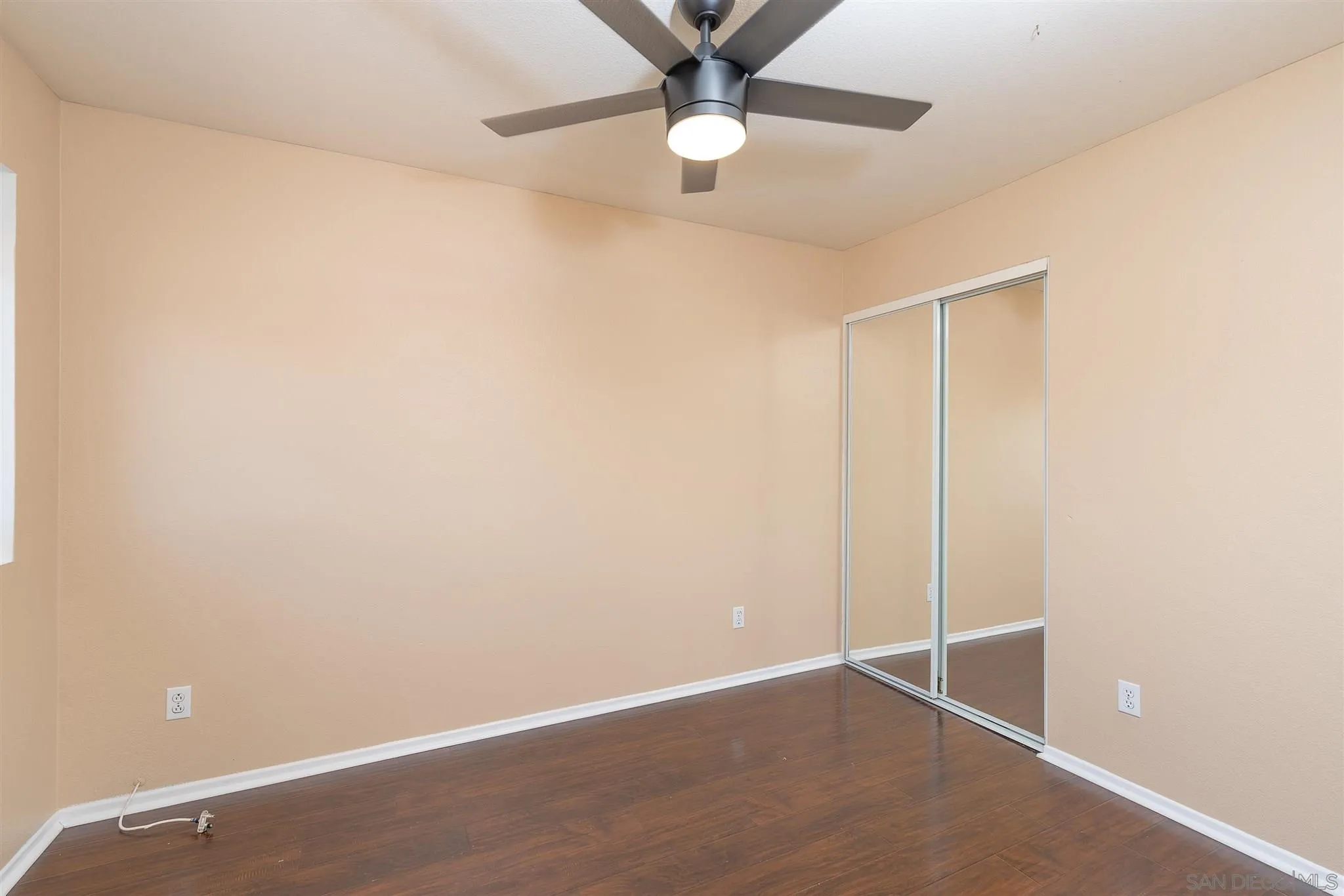 3208 Naylor Road San Diego, CA 92173 - Photo 20 of 24 an empty room with a ceiling fan and painted walls