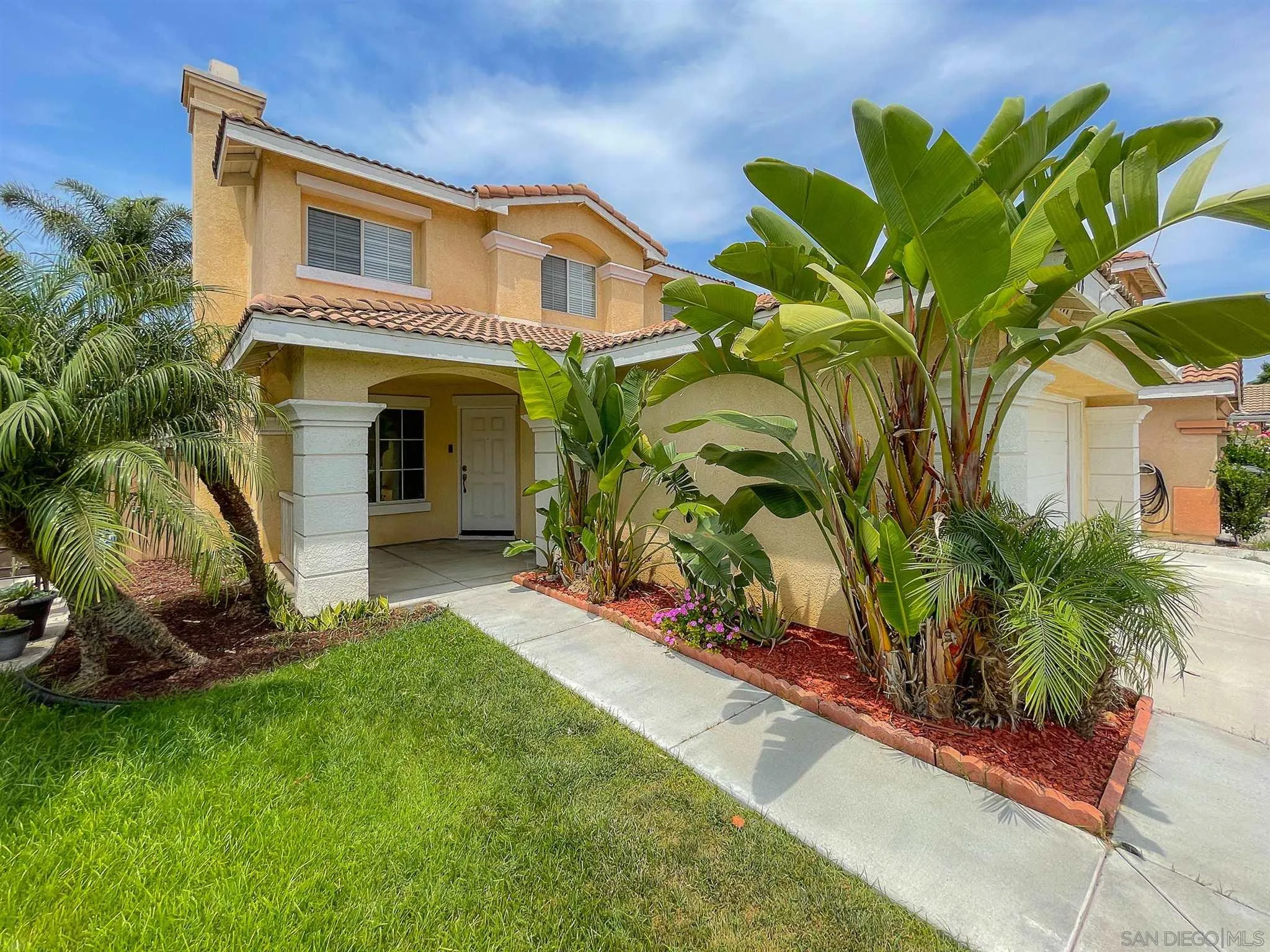 3208 Naylor Road San Diego, CA 92173 - Photo 2 of 24 a front view of a house with a yard
