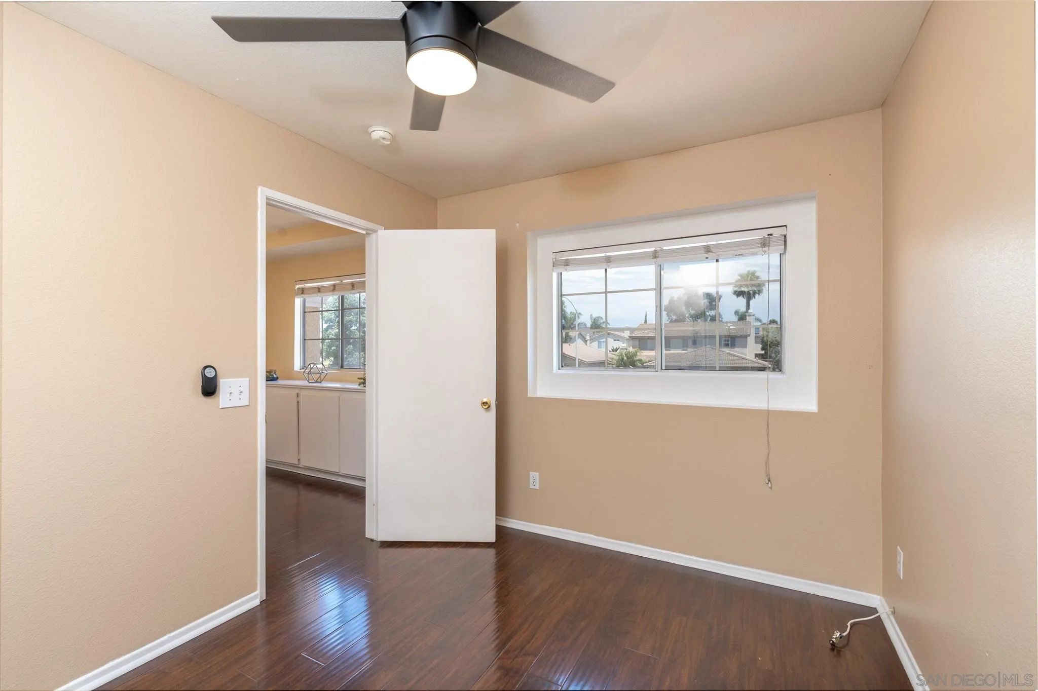 3208 Naylor Road San Diego, CA 92173 - Photo 21 of 24 an empty room with wooden floor chandelier fan and windows
