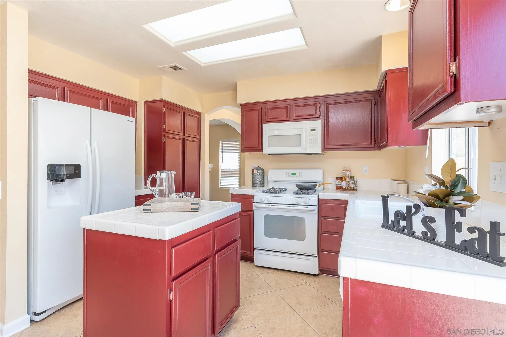 3208 Naylor Road San Diego, CA 92173 - Photo 10 of 24 a kitchen with a stove a sink and a refrigerator