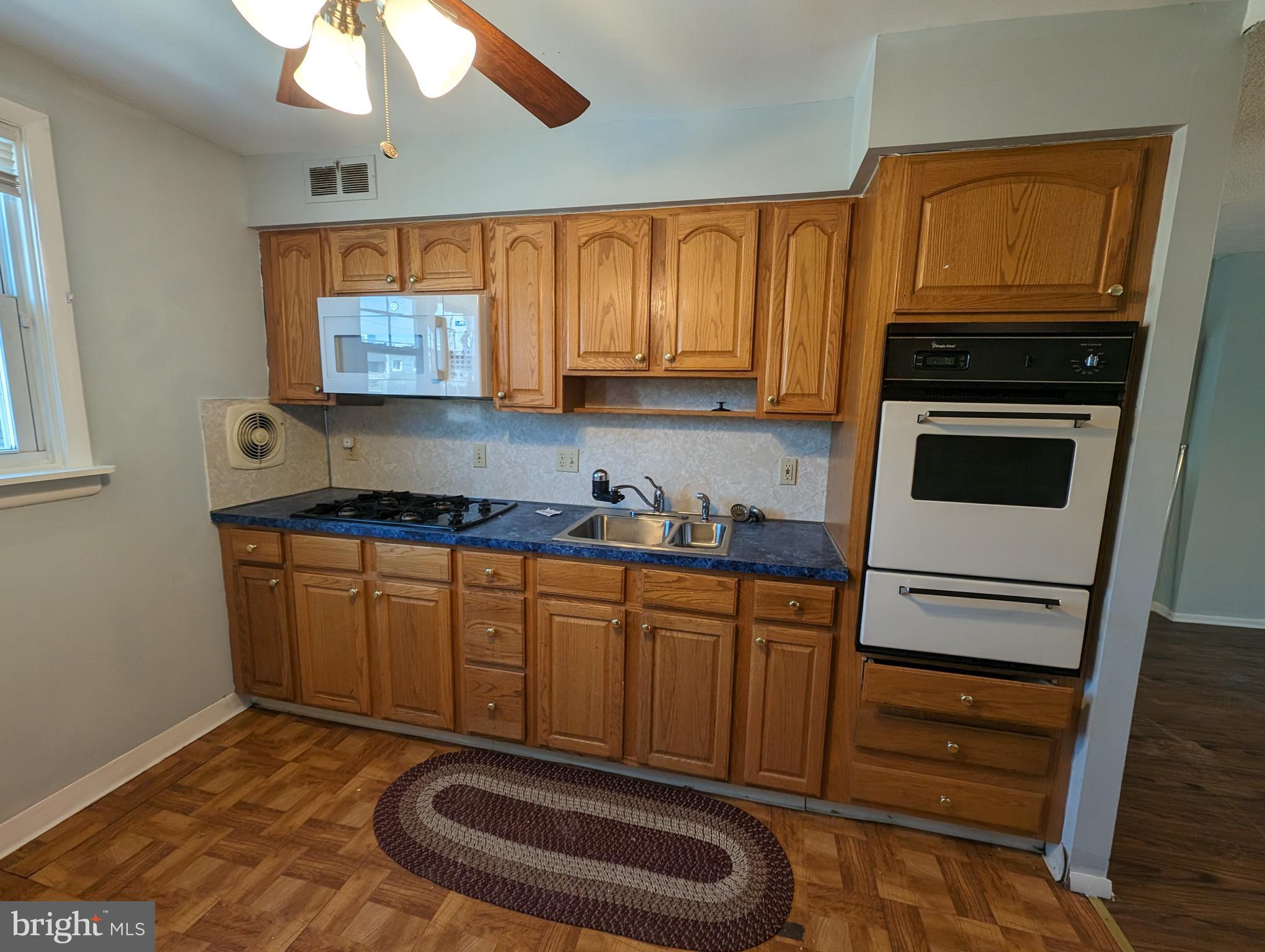1104 Master Street Philadelphia, PA 19122 - Photo 15 of 22 a kitchen with stainless steel appliances a stove a microwave and a sink