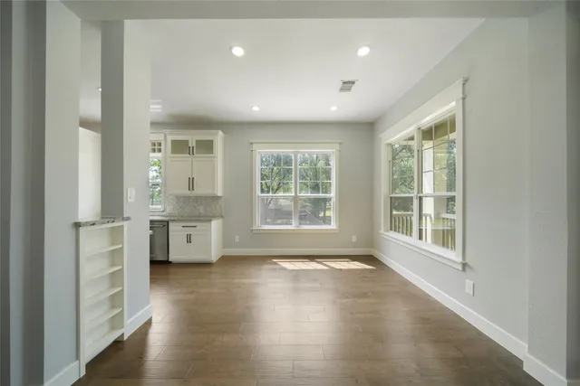 a view of outdoor space with wooden floor and windows