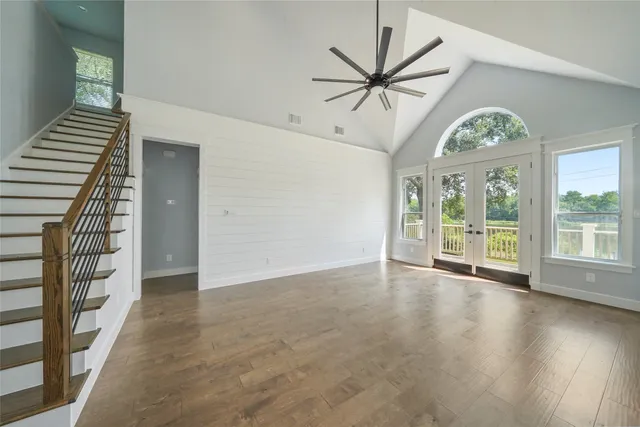 wooden floor in an empty room with a window