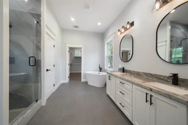 a bathroom with a glass shower door
