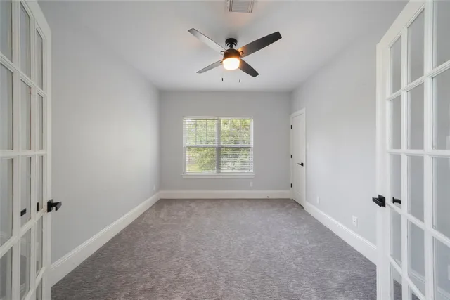 an empty room with a bathroom and a shower