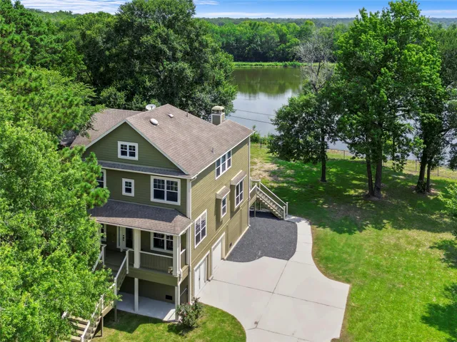 a aerial view of a house with a yard table and chairs