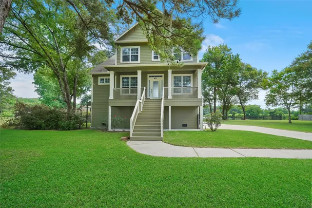 a view of house with garden and a trees