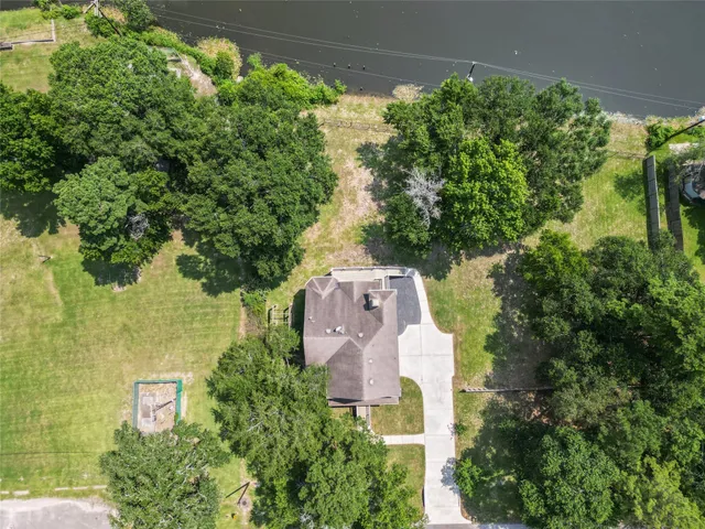 an aerial view of a house with a yard and garden