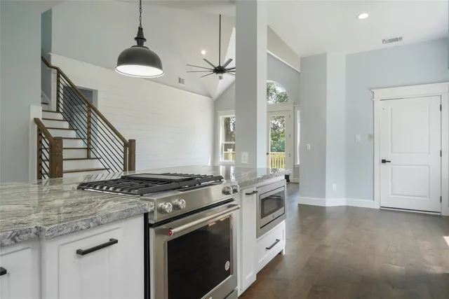 a kitchen with stainless steel appliances granite countertop a stove and a sink