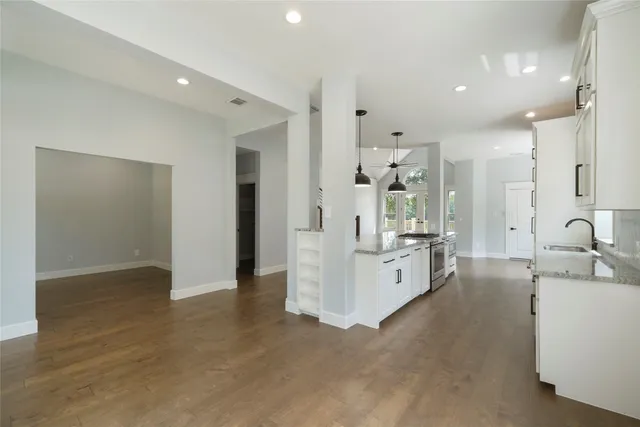 a large white kitchen with white cabinets