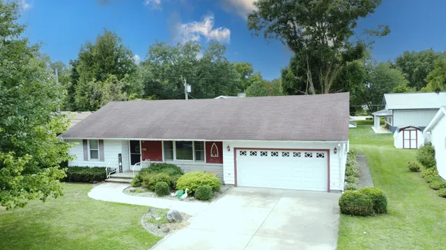 a view of a house with garden and yard