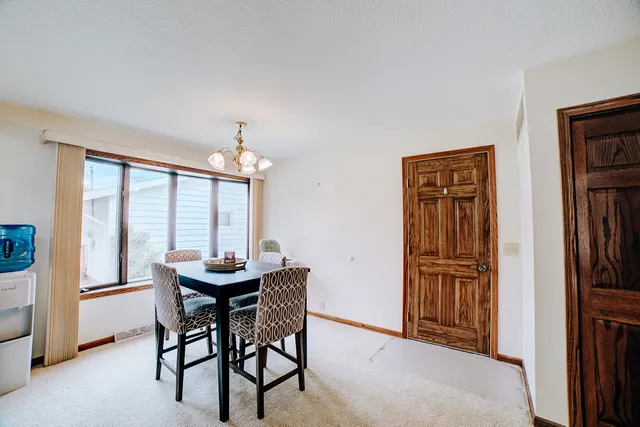 a dining room with furniture window and wooden floor