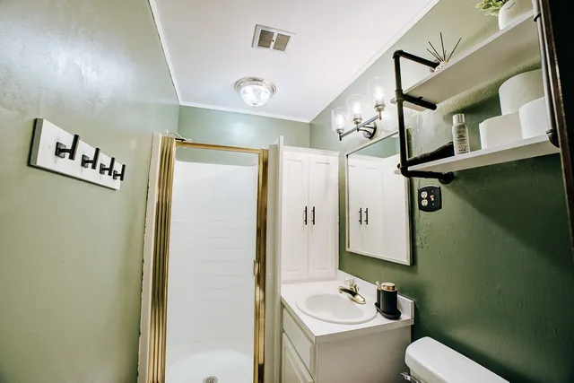 a bathroom with a toilet sink and mirror