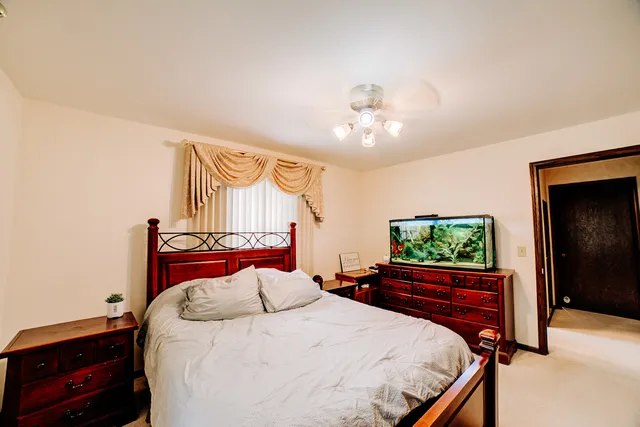 a bedroom with a bed and a chandelier