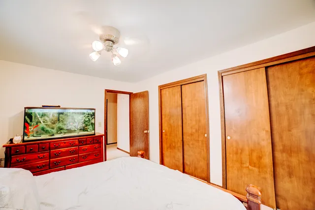 a bedroom with a large bed and a large window