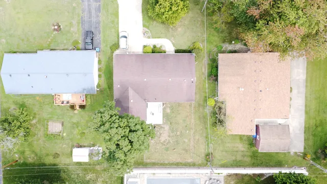 an aerial view of a house with a yard