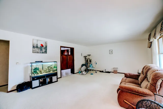 a living room with furniture a window and a flat screen tv