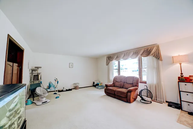 a living room with furniture gym equipment and a flat screen tv
