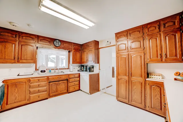 a large kitchen with stainless steel appliances granite countertop a sink and cabinets