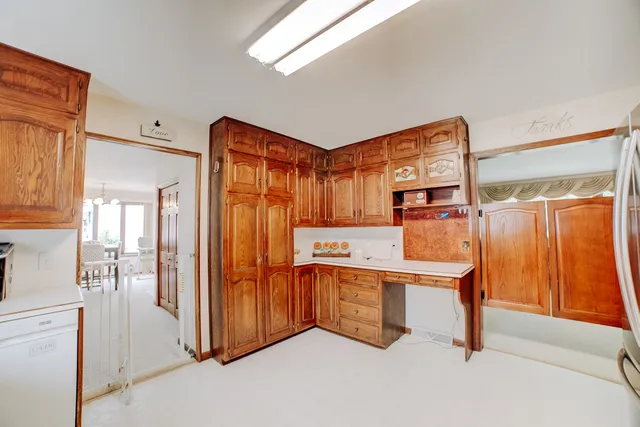 a view of a kitchen with stainless steel appliances granite countertop furniture and a refrigerator