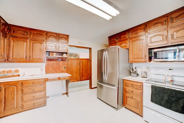 a kitchen that has a sink cabinets and stainless steel appliances