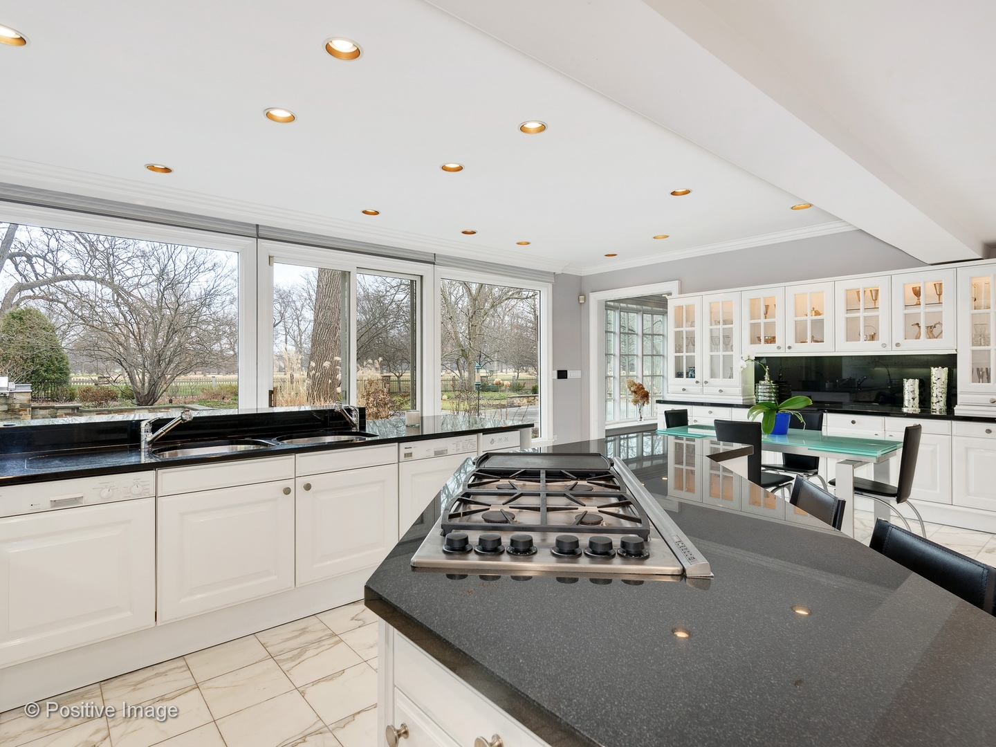 32 Indian Hill Road Winnetka, IL 60093 - Photo 18 of 79 a kitchen with sink a stove and white cabinets
