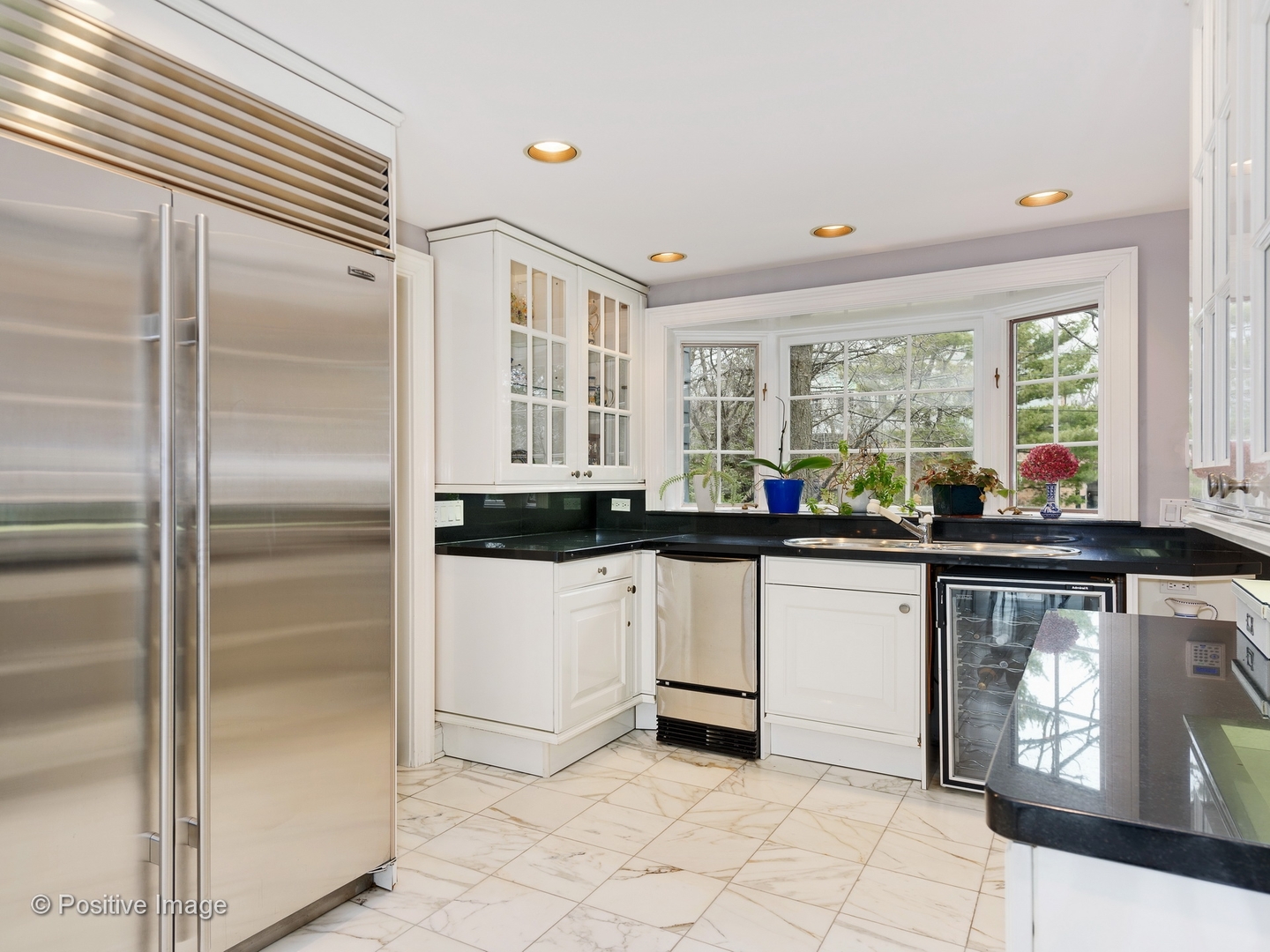32 Indian Hill Road Winnetka, IL 60093 - Photo 20 of 79 a kitchen with stainless steel appliances granite countertop a sink and a refrigerator