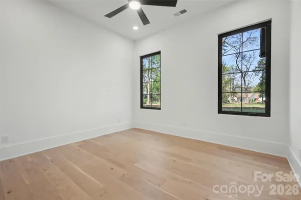 an empty room with windows and closet