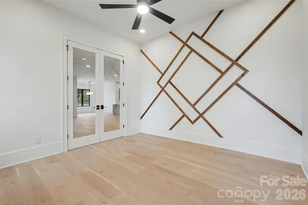 a view of a livingroom with wooden floor and stairs