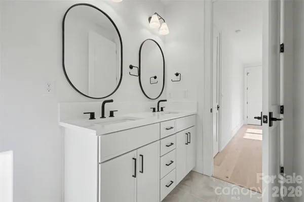 a bathroom with 2 sink and a mirror