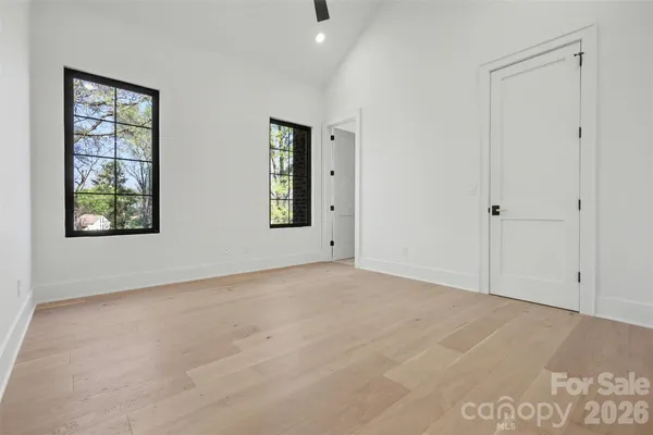 an empty room with windows and closet