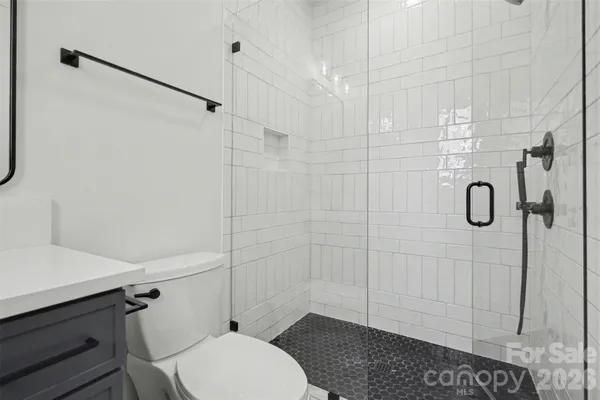 a bathroom with a toilet and shower