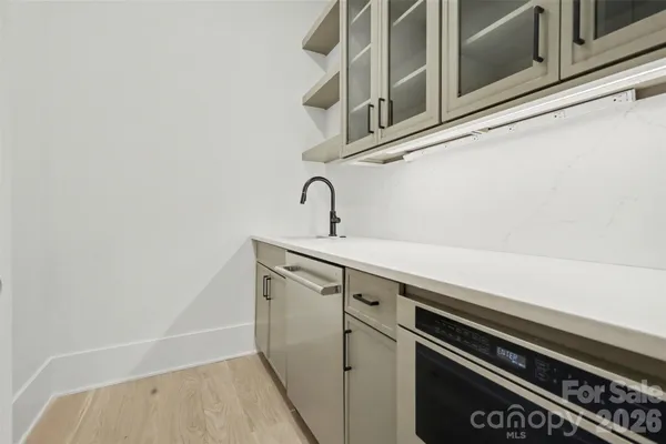 a close view of a sink and a stove in the kitchen